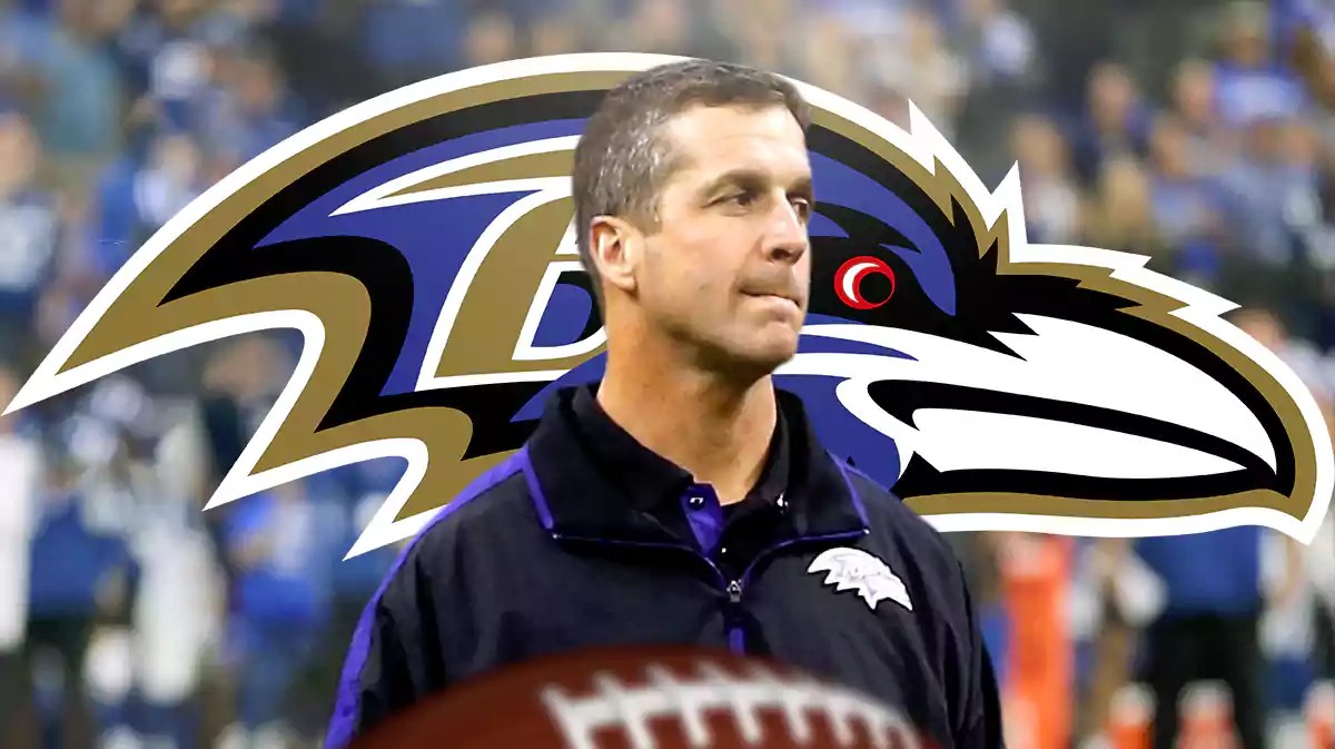 Baltimore Ravens head coach John Harbaugh, with Ravens logo behind him.