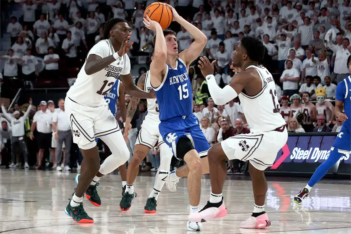 Kentucky Wildcats guard Reed Sheppard (15) scores on the final shot of the game as Mississippi State Bulldogs forward KeShawn Murphy (12) and guard Josh Hubbard (13) defend during the second half at Humphrey Coliseum.