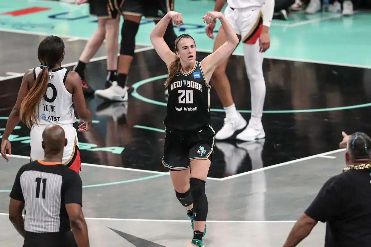 Sabrina Ionescu on New York Liberty putting her hands up in celebration.