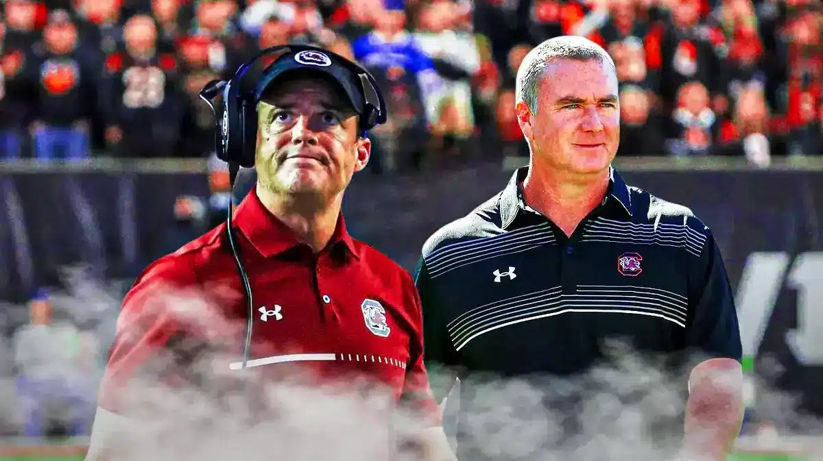South Carolina football coach Shane Beamer smiling next to former Georgia State head coach Shawn Elliott