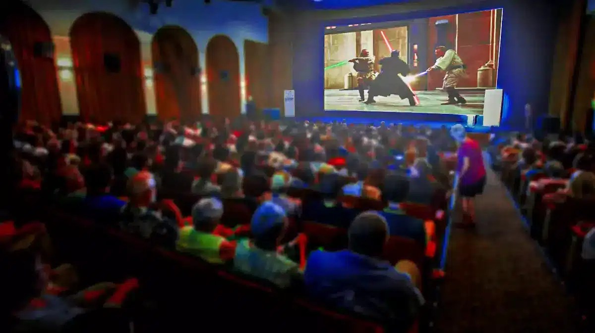 Star Wars Episode 1 playing on a movie screen in a packed theater