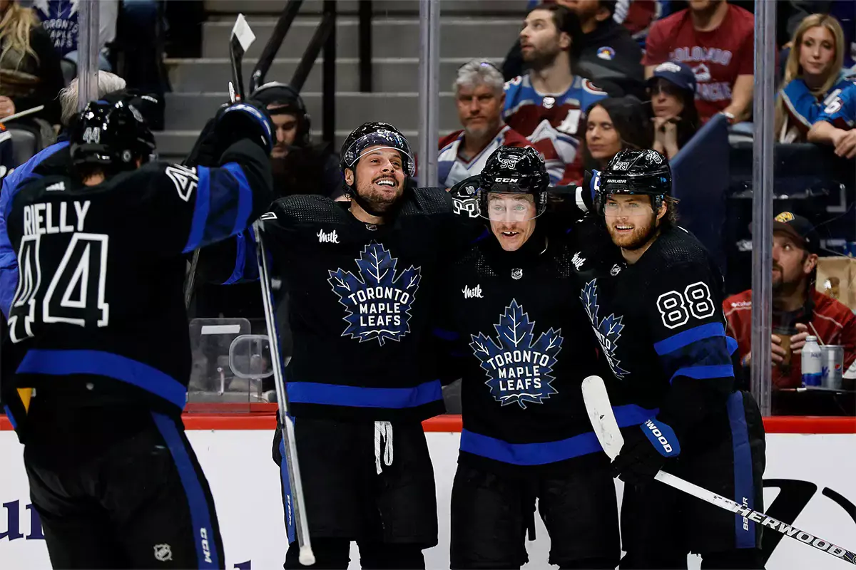 Toronto Maple Leafs left wing Tyler Bertuzzi (59) celebrates his hat trick goal with center Auston Matthews (34) and right wing William Nylander (88) and defenseman Morgan Rielly (44) in the third period against the Colorado Avalanche at Ball Arena.