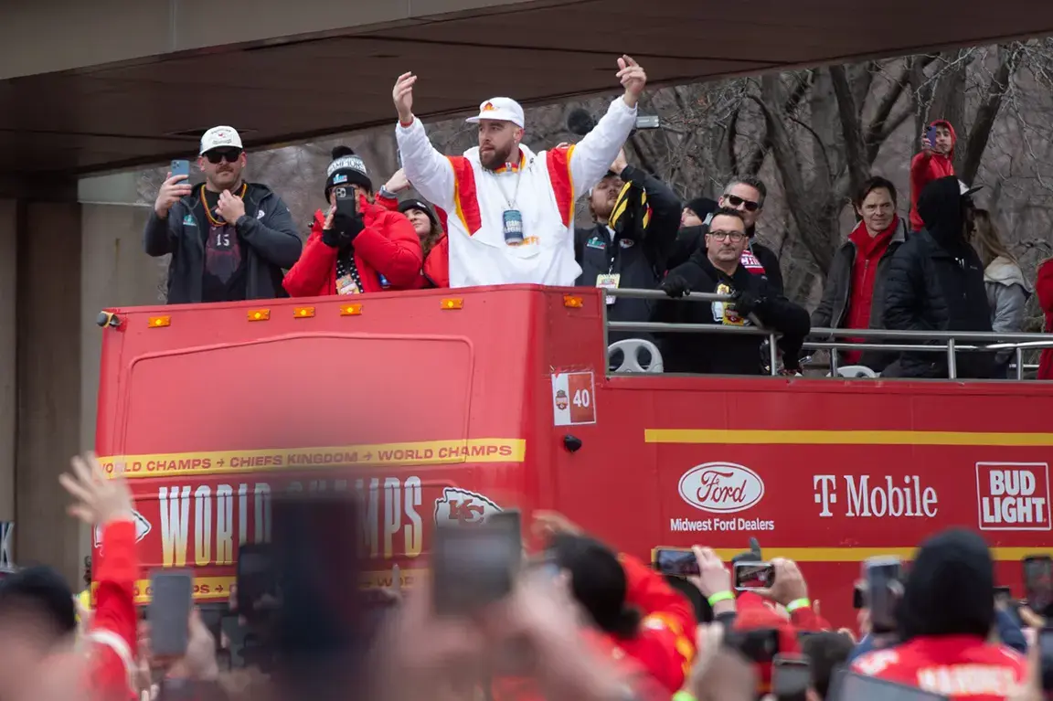 Travis Kelce on a parade float for the Super Bowl parade.