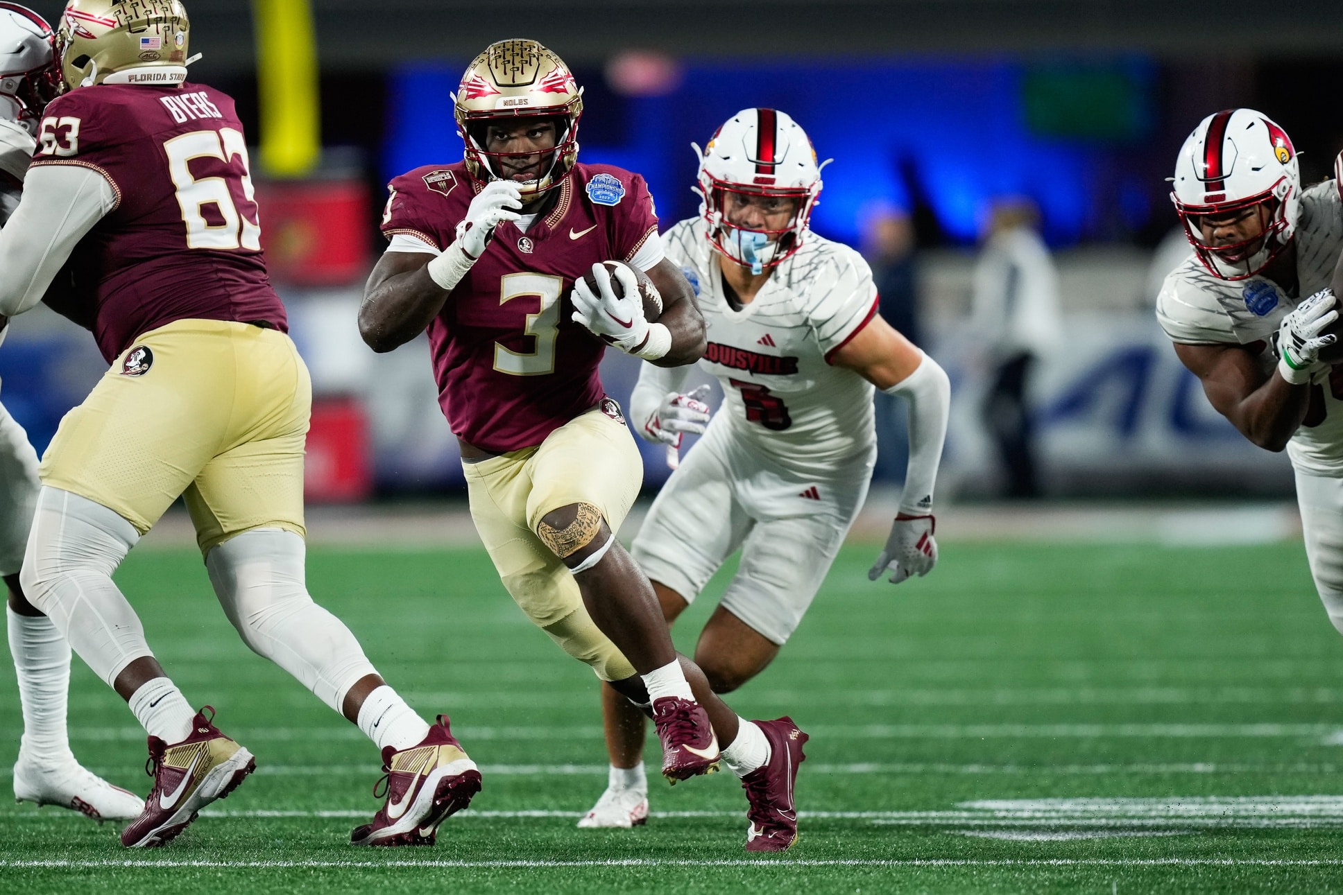 Florida State Seminoles running back Trey Benson (3) runs the ball against the Louisville Cardinals during the fourth quarter at Bank of America Stadium.