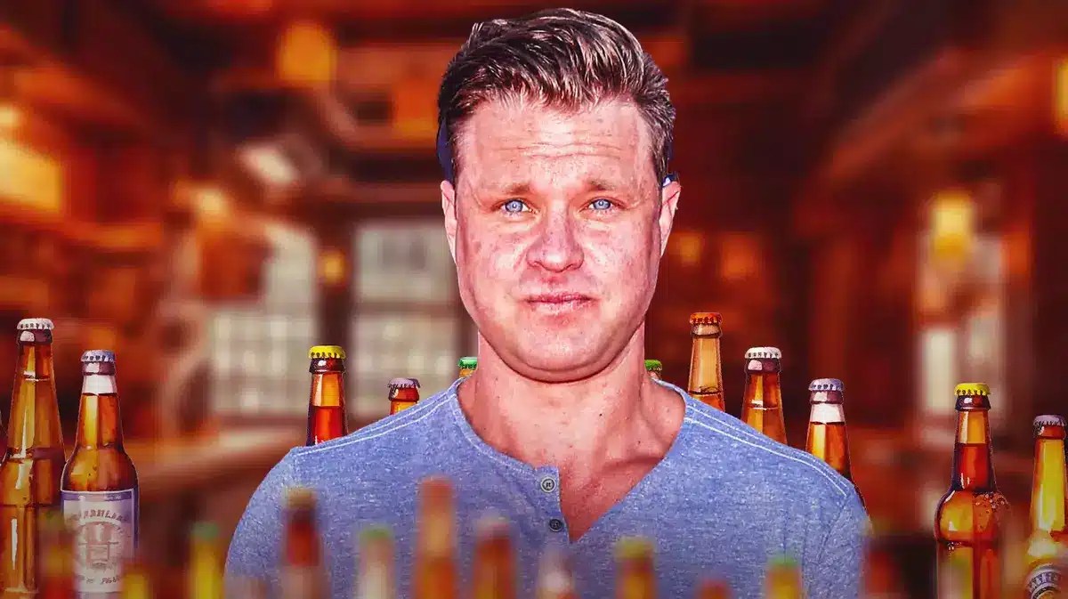 Zachery Ty Bryan with beer bottles around him.