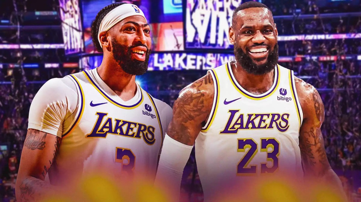 Lakers' Anthony Davis on the left, smiling at LeBron James, who is on the right.