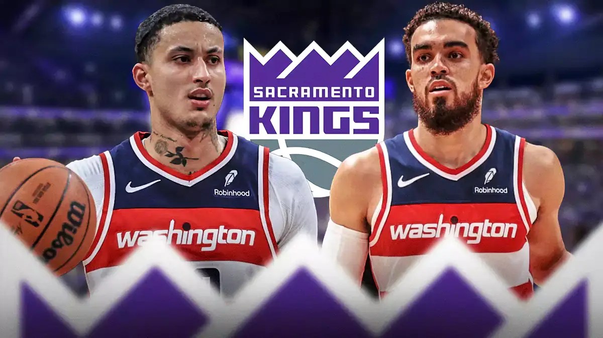 Kyle Kuzma and Tyus Jones next to the Kings logo