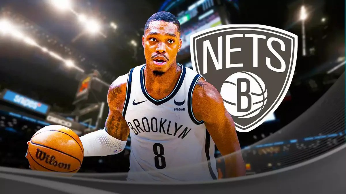 Lonnie Walker next to a Nets logo at Barclays Center