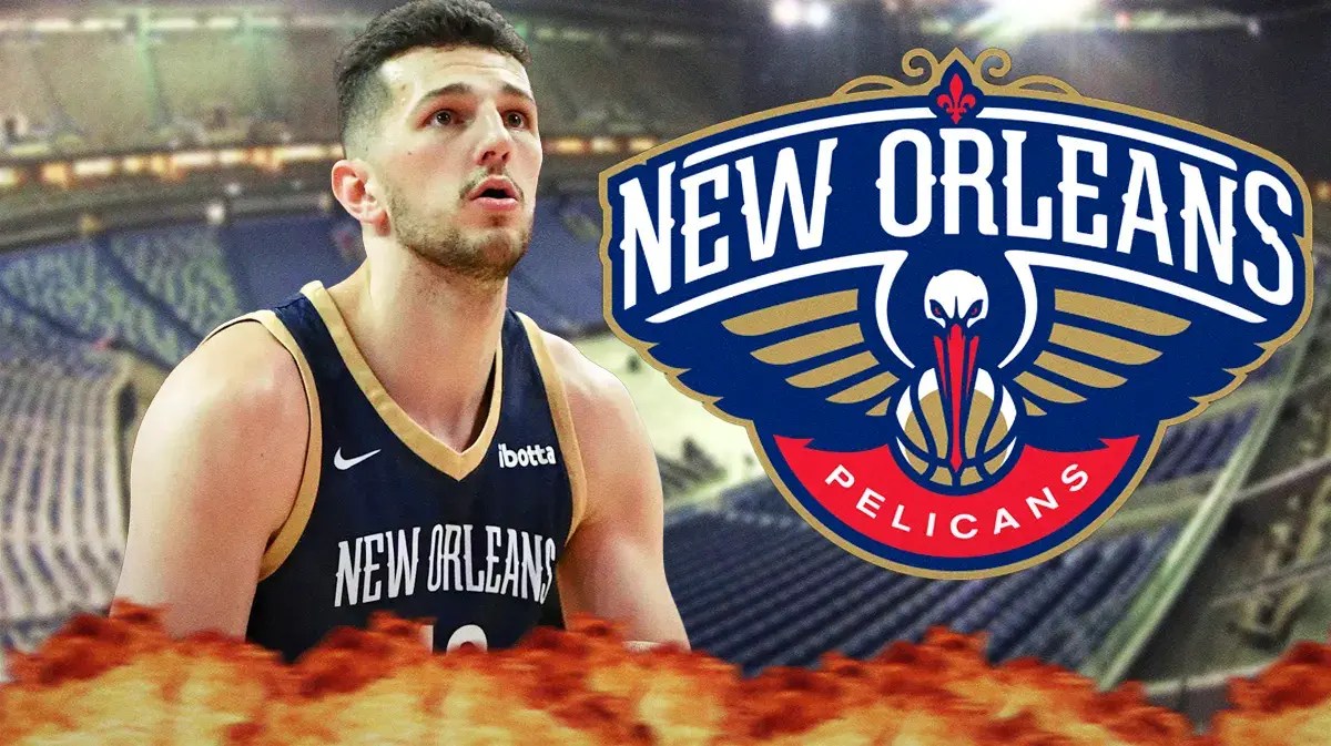 Karlo Matkovic next to a Pelicans logo at Smoothie King Center