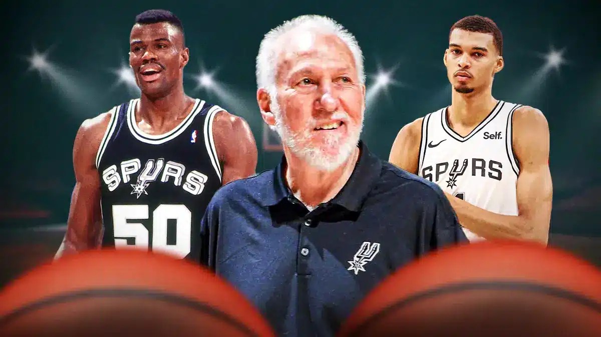 Spurs coach Gregg Popovich smiling with David Robinson (in Spurs jersey) on one side and Victor Wembanyama on the other.