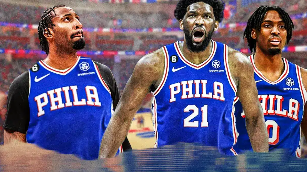 Andre Drummond in 76ers uniform next to Joel Embiid and Tyrese Maxey