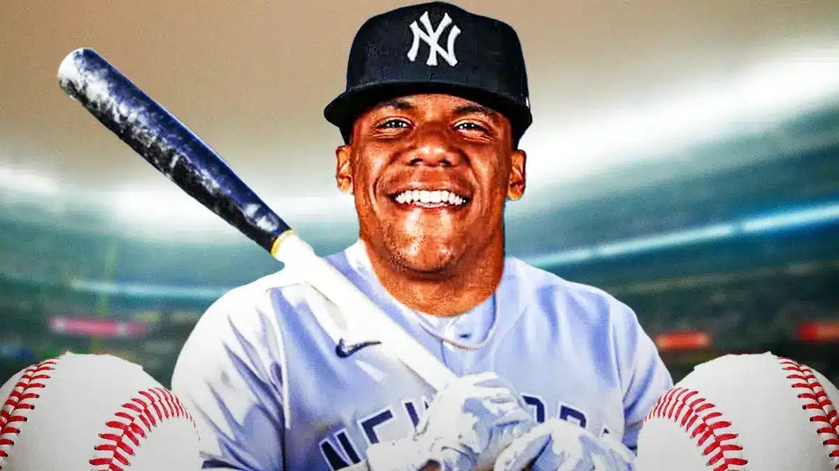 Juan Soto swinging a bat in a Yankees uniform. Yankee Stadium in background