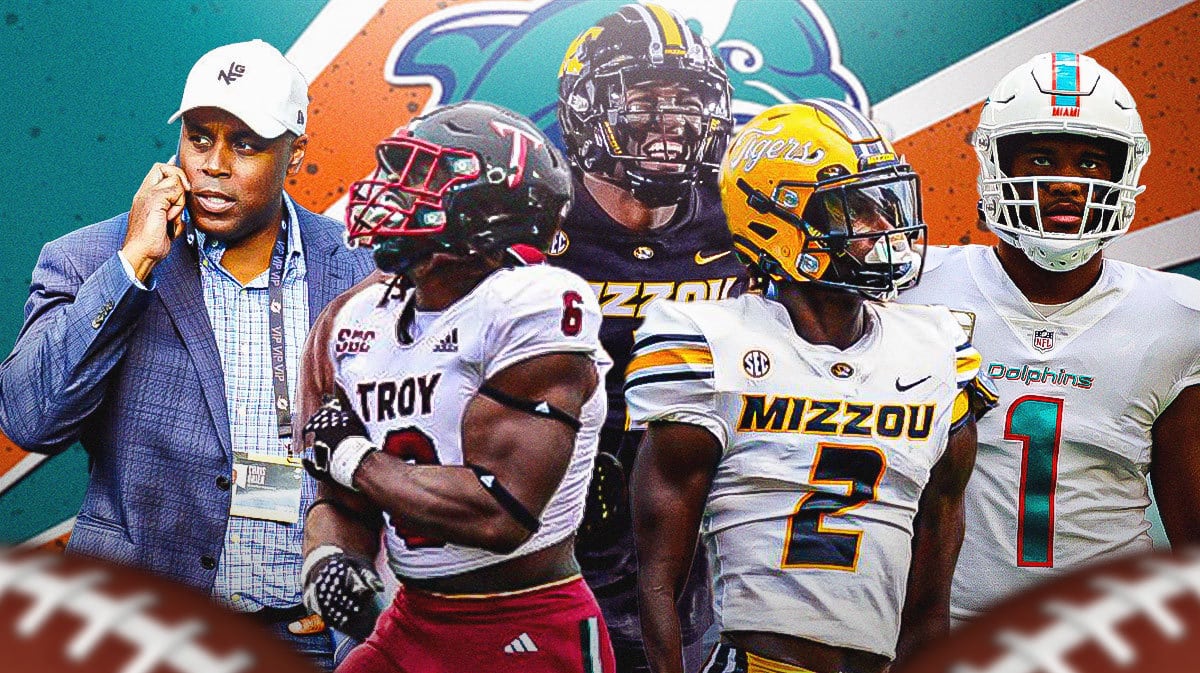 Ennis Rakestraw Jr, Javon Solomon, Jaylon Carlies in the middle, Tua Tagovailoa and GM Chris Grier around them, and Miami Dolphins wallpaper in the background