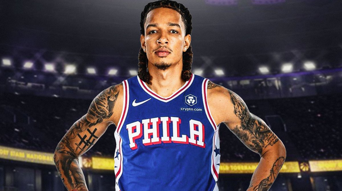 DJ Wilson in a 76ers jersey with the 76ers arena in the background