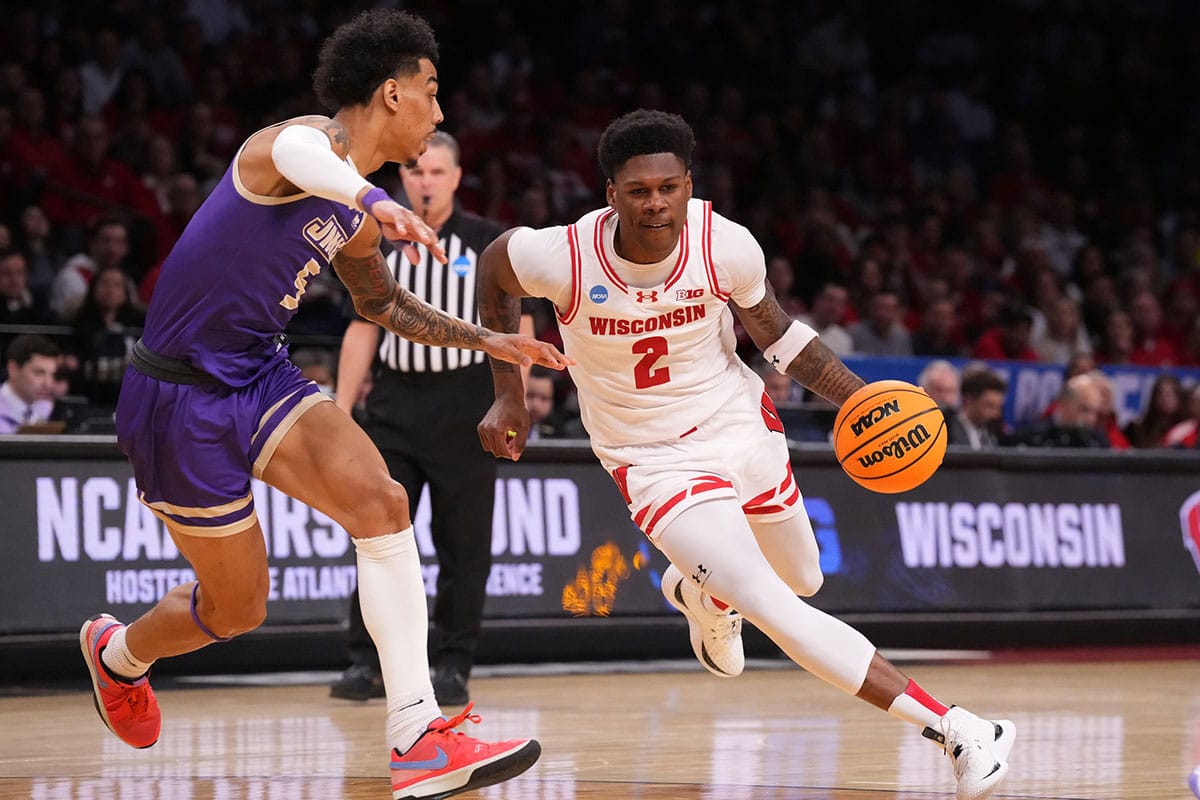 Wisconsin Badgers guard AJ Storr (2) dribbles the ball against James Madison Dukes guard Terrence Edwards Jr. (5) in the first round of the 2024 NCAA Tournament at the Barclays Center.