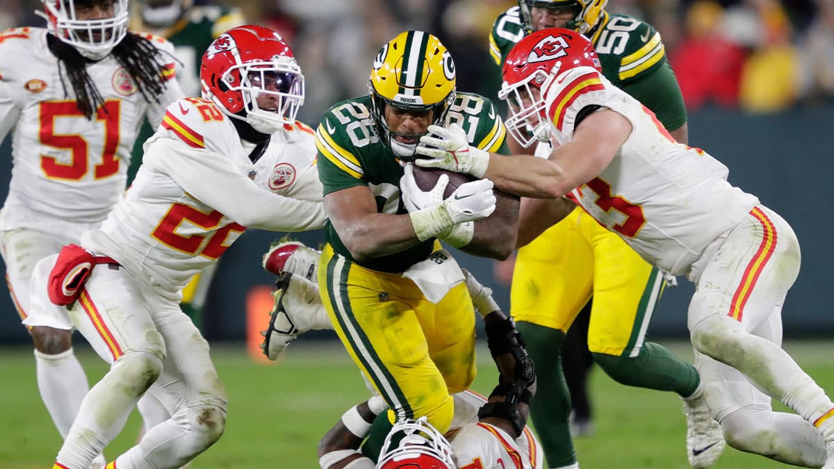 Green Bay Packers running back AJ Dillon (28) runs for a first down against the Kansas City Chiefs at Lambeau Field