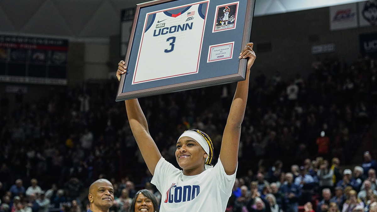 UConn Huskies forward Aaliyah Edwards (3) holds up her jersey during senior night after defeating the Georgetown Hoyas
