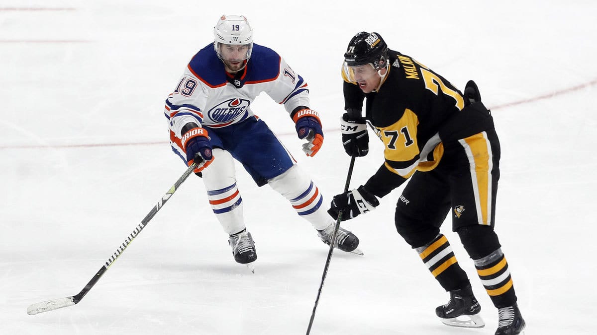 Pittsburgh Penguins center Evgeni Malkin (71) moves the puck against Edmonton Oilers center Adam Henrique (19) during the third period at PPG Paints Arena. The Oilers won 4-0.