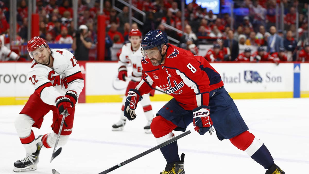 Washington Capitals left wing Alex Ovechkin (8) controls the puck as Carolina Hurricanes defenseman Brett Pesce (22) defends during the first period at Capital One Arena