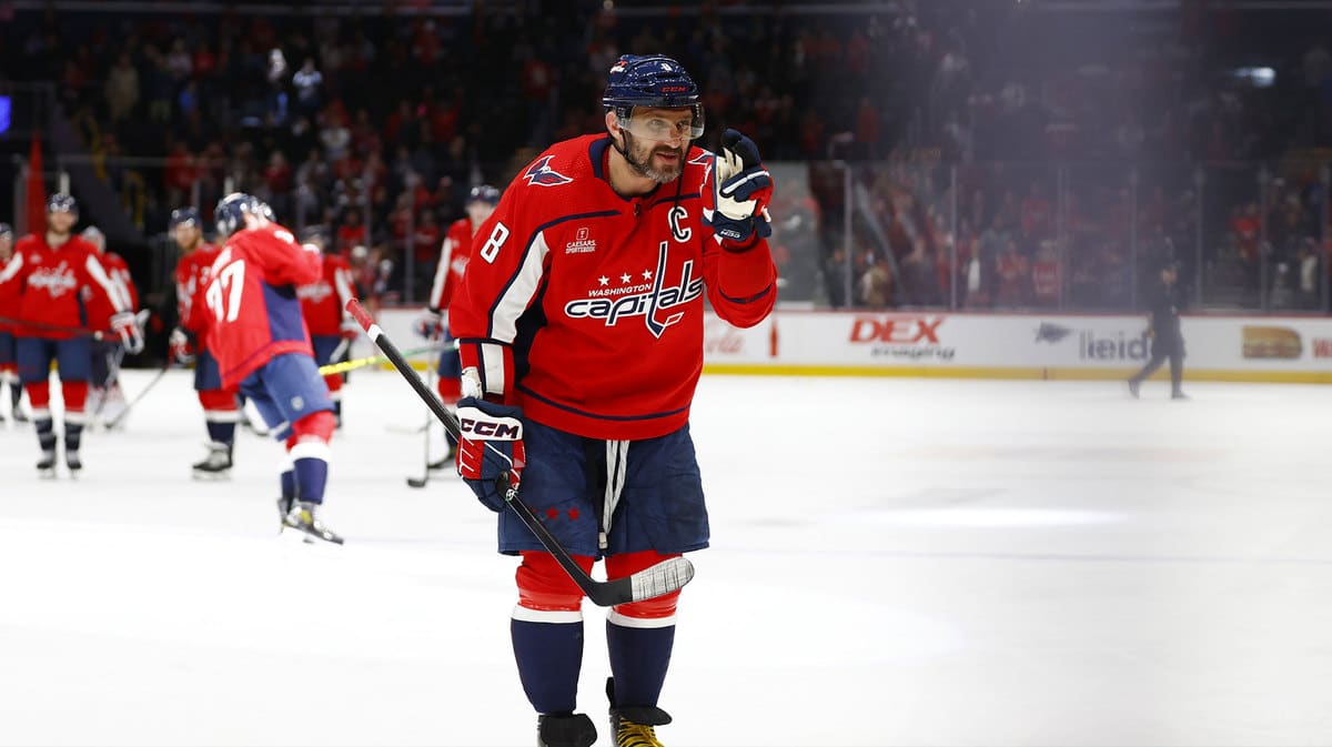 Washington Capitals left wing Alex Ovechkin (8) waves to his sons in the stands after defeating the Winnipeg Jets at Capital One Arena.