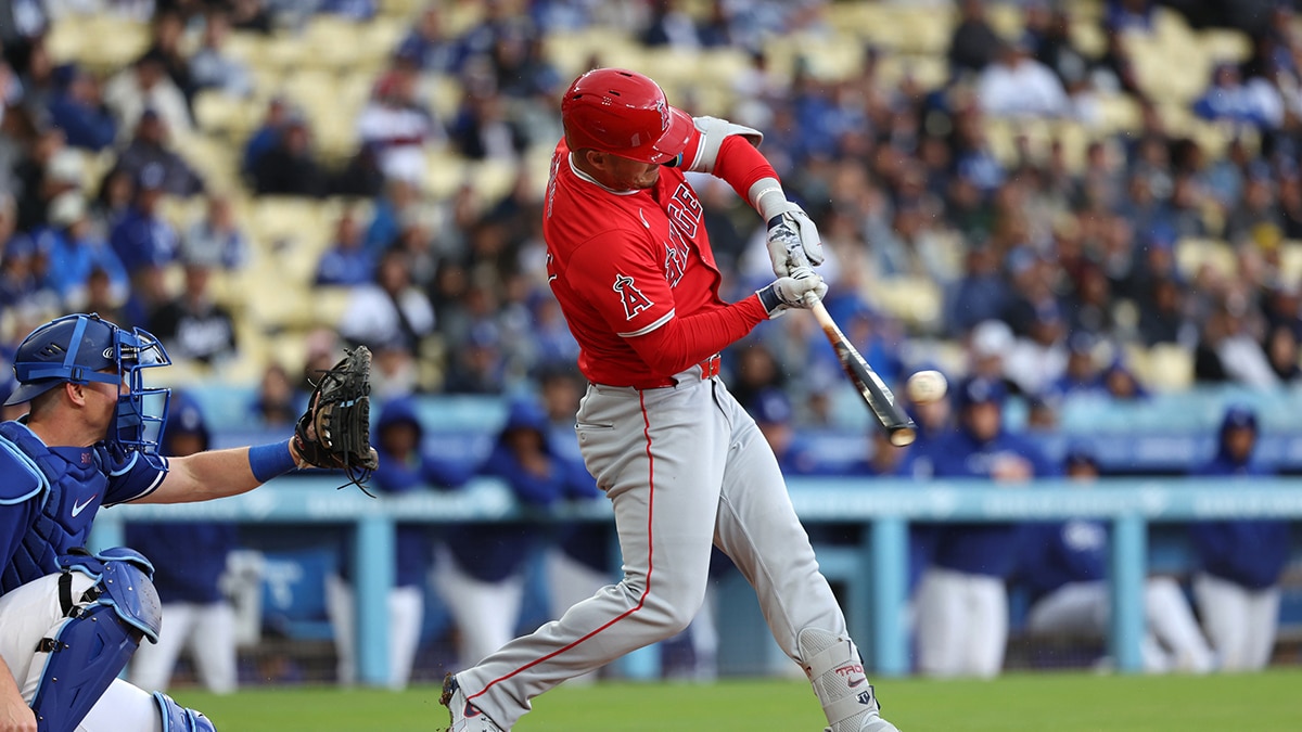  Los Angeles Angels center fielder Mike Trout (27) hits a single during the third inning against the Los Angeles Dodgers at Dodger Stadium.
