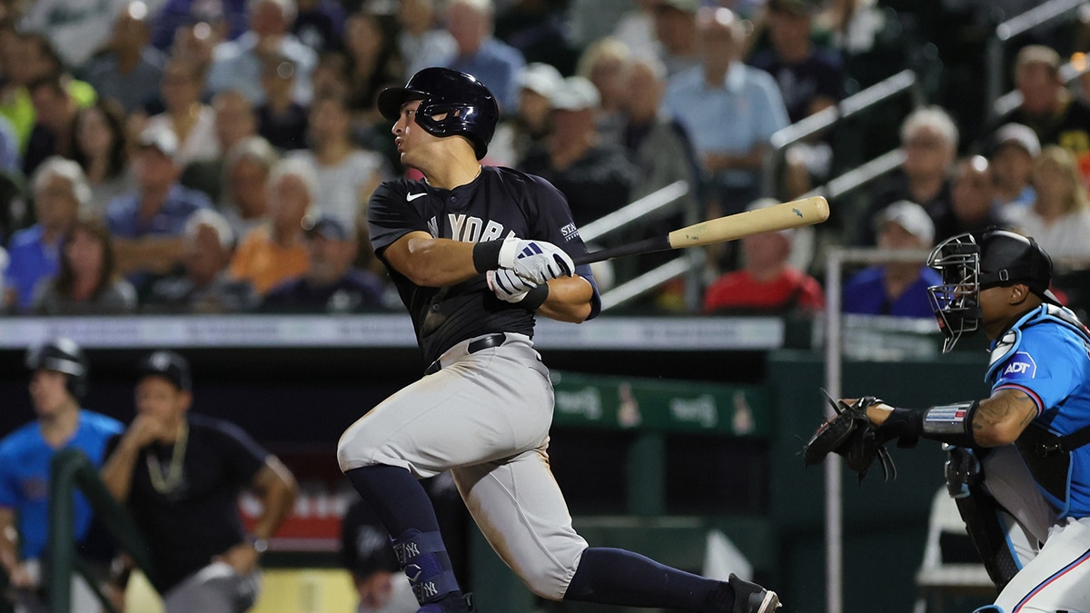 New York Yankees shortstop Anthony Volpe (11) hits a single against the Miami Marlins during the fifth inning at Roger Dean Chevrolet Stadium.