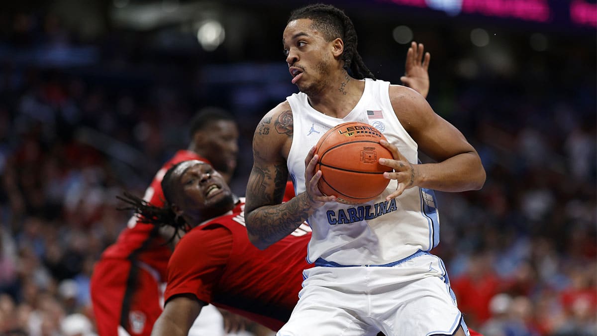 North Carolina Tar Heels forward Armando Bacot (5) attempts to shoot the ball on North Carolina State Wolfpack forward DJ Burns Jr. (30) during the second half at Capital One Arena