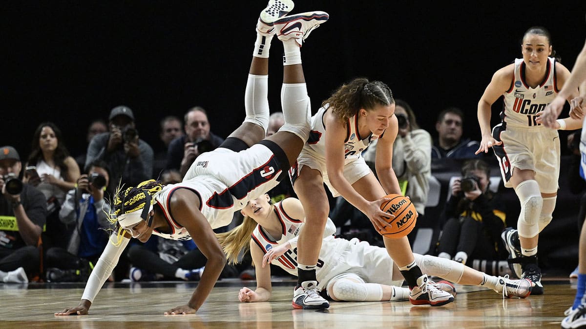 UConn Huskies forward Aaliyah Edwards (3) flips over guard Ashlynn Shade (12) during the first half against the Duke Blue Devils in the semifinals of the Portland Regional of the 2024 NCAA Tournament at the Moda Center.