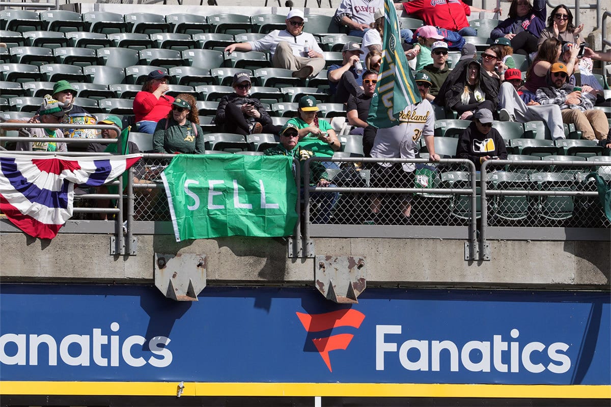 An Oakland Athletics fan displays a “Sell” sign during the fifth inning against the Cleveland Guardians at Oakland-Alameda County Coliseum.