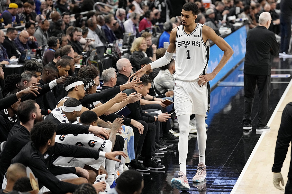 San Antonio Spurs forward Victor Wembanyama (1) reacts with teammates when heading to the bench during the first half against the Denver Nuggets at Moody Center. 