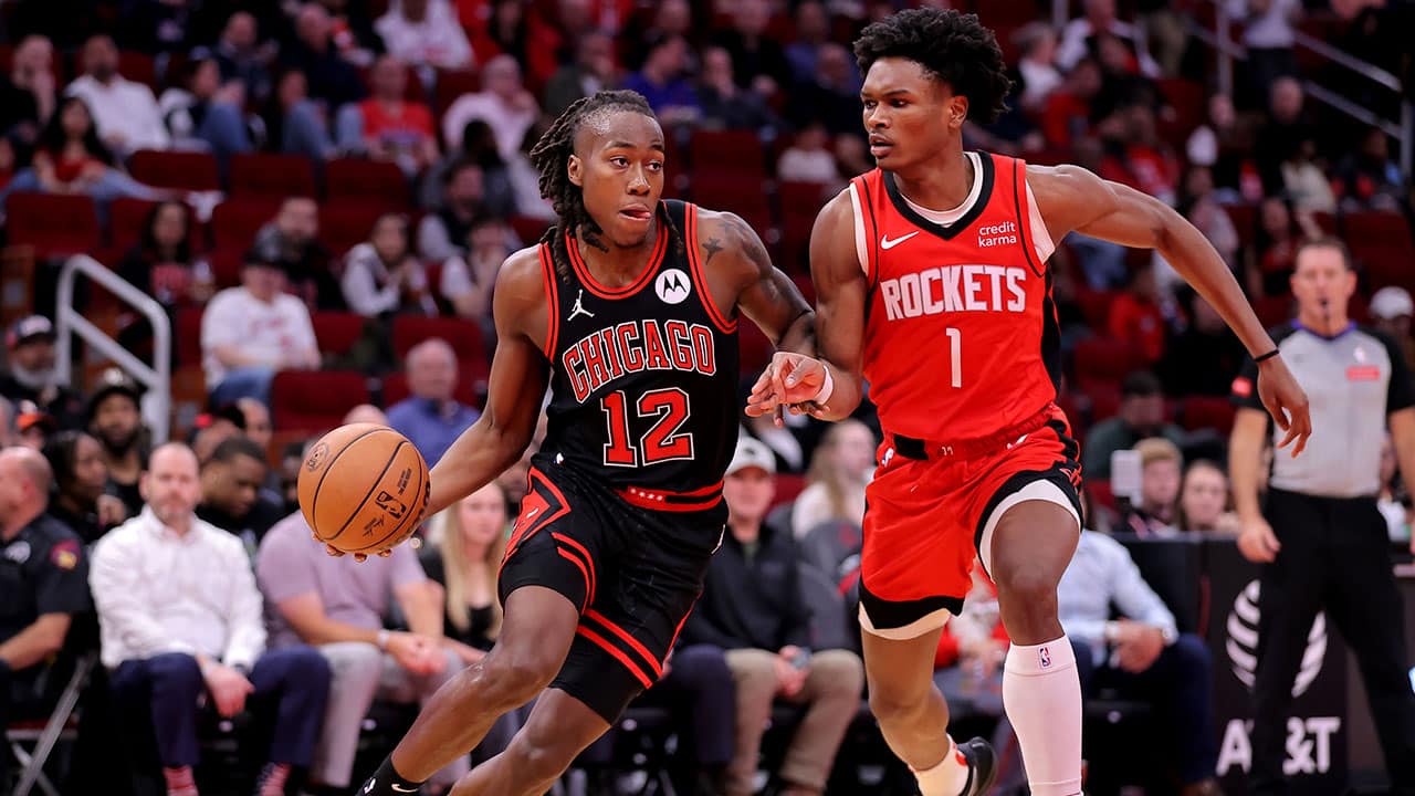 Chicago Bulls guard Ayo Dosunmu (12) handles the ball against Houston Rockets forward Amen Thompson (1) during the second quarter at Toyota Center.