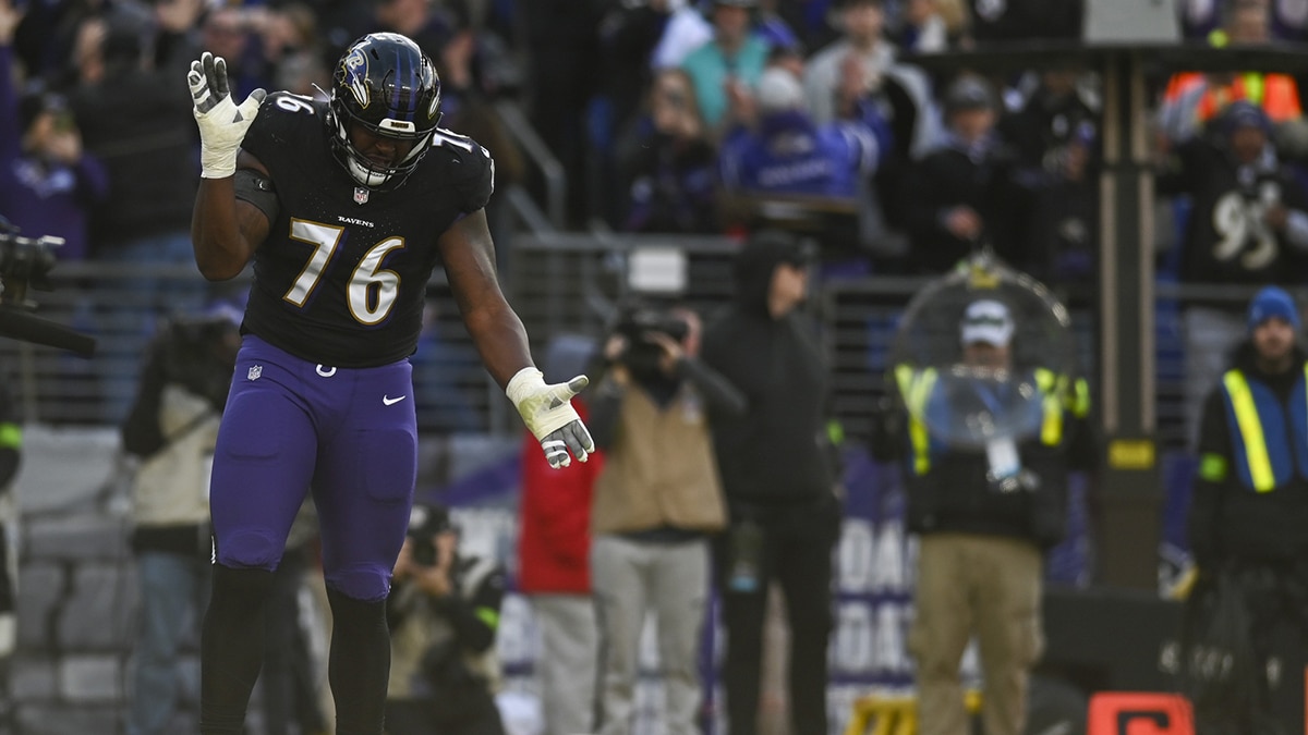 Baltimore Ravens guard John Simpson (76) reacts after running back Gus Edwards (35) touchdown against the Miami Dolphins during the first half at M&T Bank Stadium