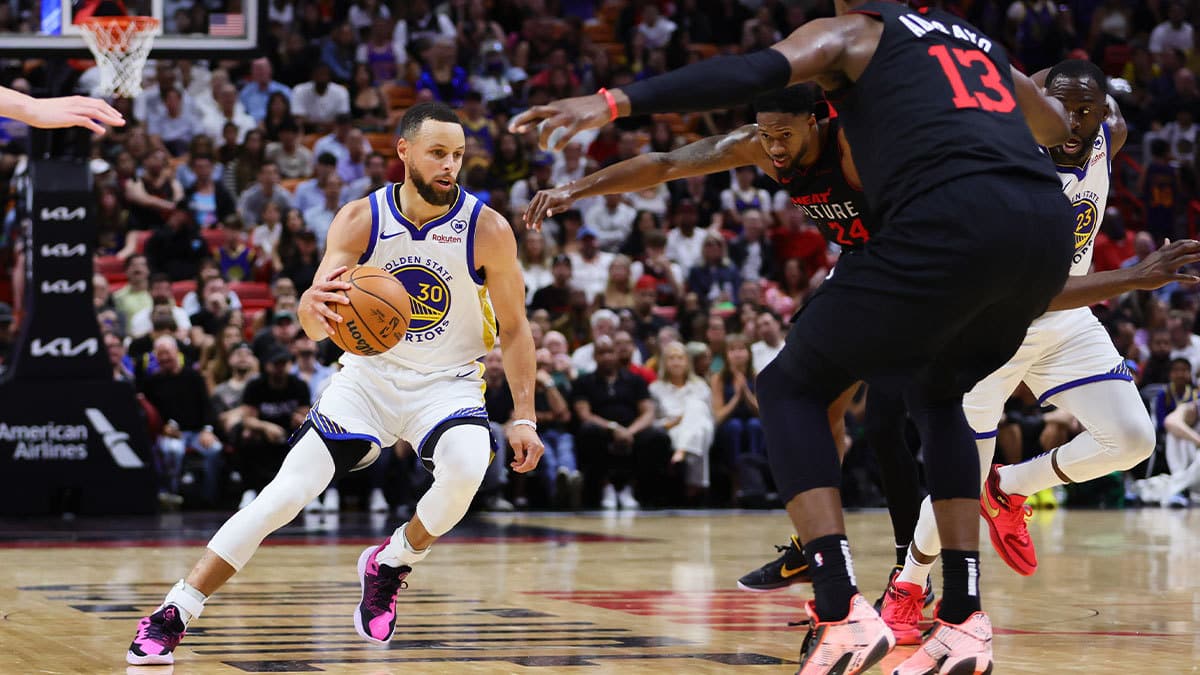 Golden State Warriors guard Stephen Curry (30) dribbles the basketball against the Miami Heat during the second quarter at Kaseya Center.