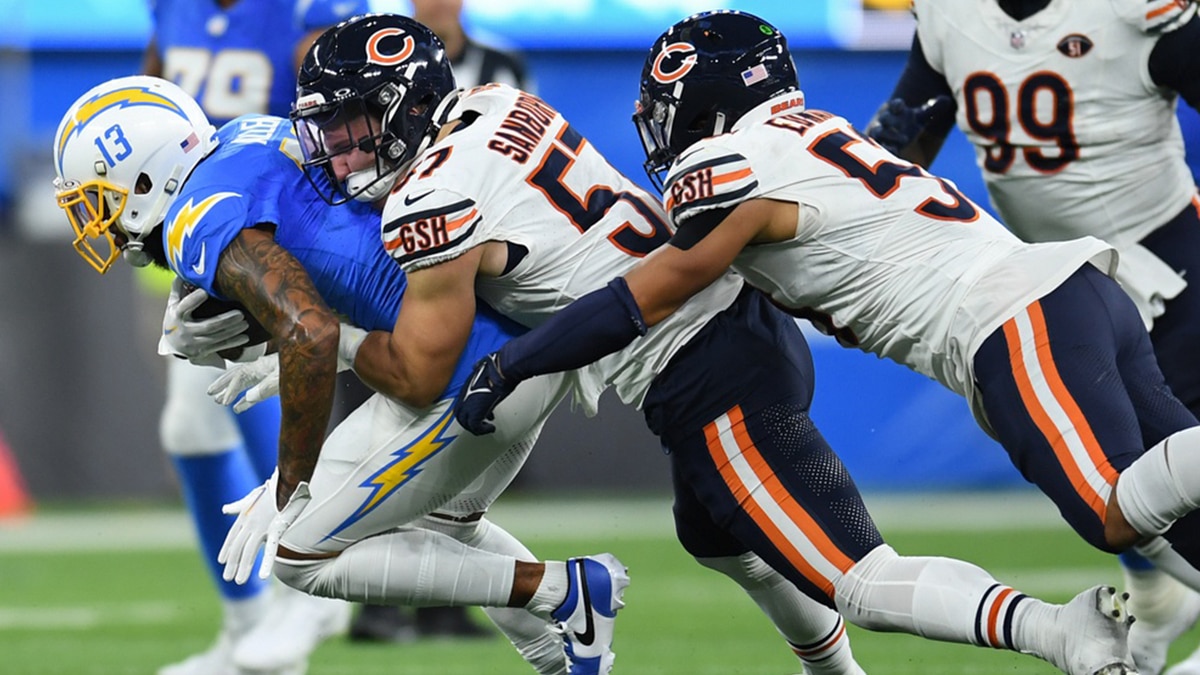 Chicago Bears linebacker Jack Sanborn (57) tackles Los Angeles Chargers wide receiver Keenan Allen (13) during the third quarter at SoFi Stadium.