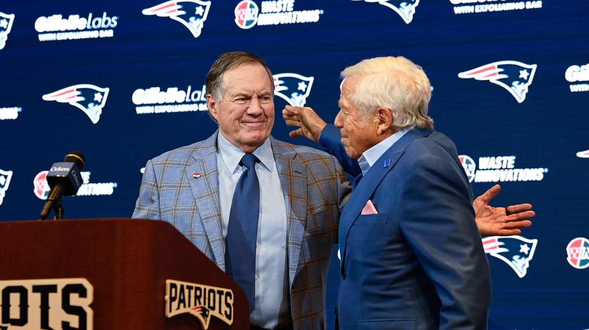 New England Patriots former head coach Bill Belichick (left) embraces Patriots owner Robert Kraft (right) during a press conference at Gillette Stadium to announce Belichick's exit from the team.