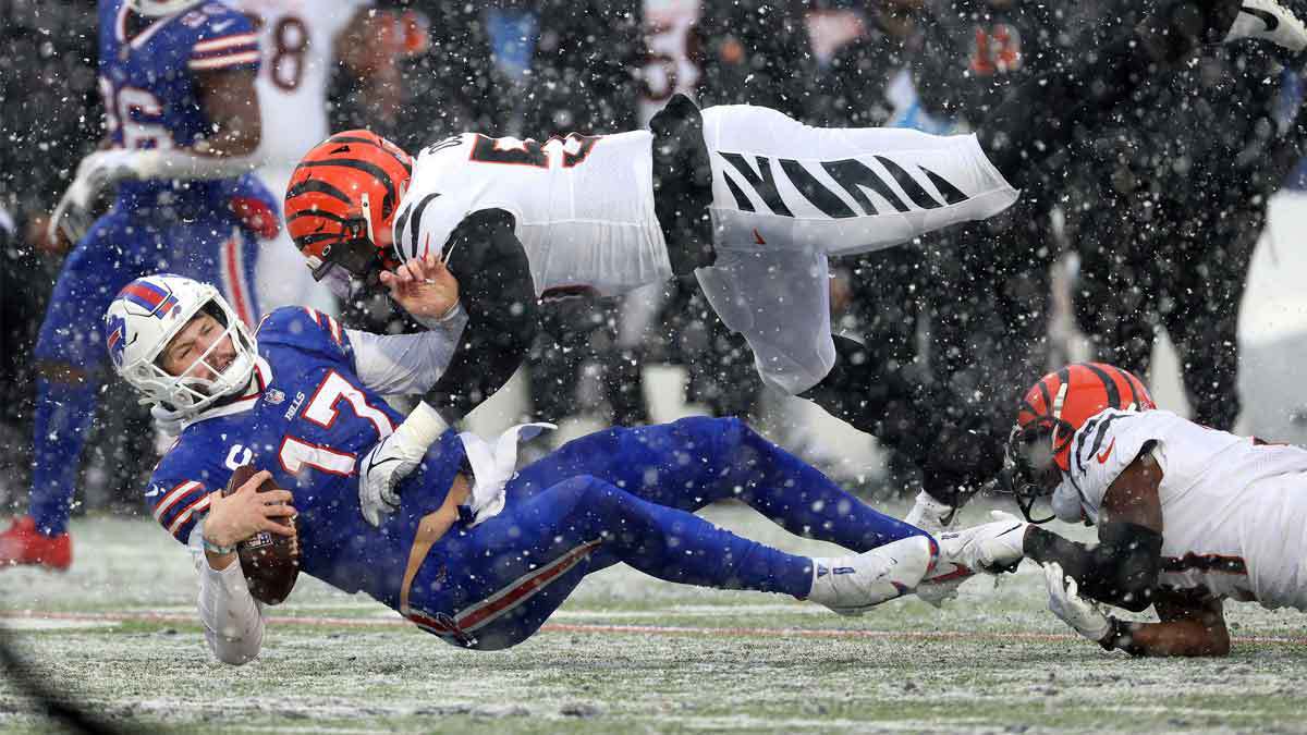 Bills quarterback Josh Allen takes a big hit after running for a first down against the Bengals