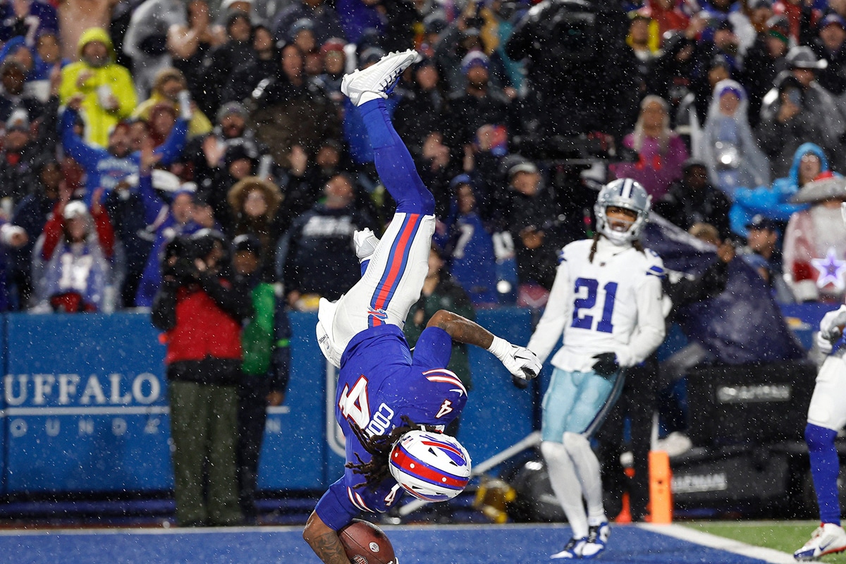 Buffalo Bills running back James Cook (4) does a flip into the end zone after his 24-yard touchdown run