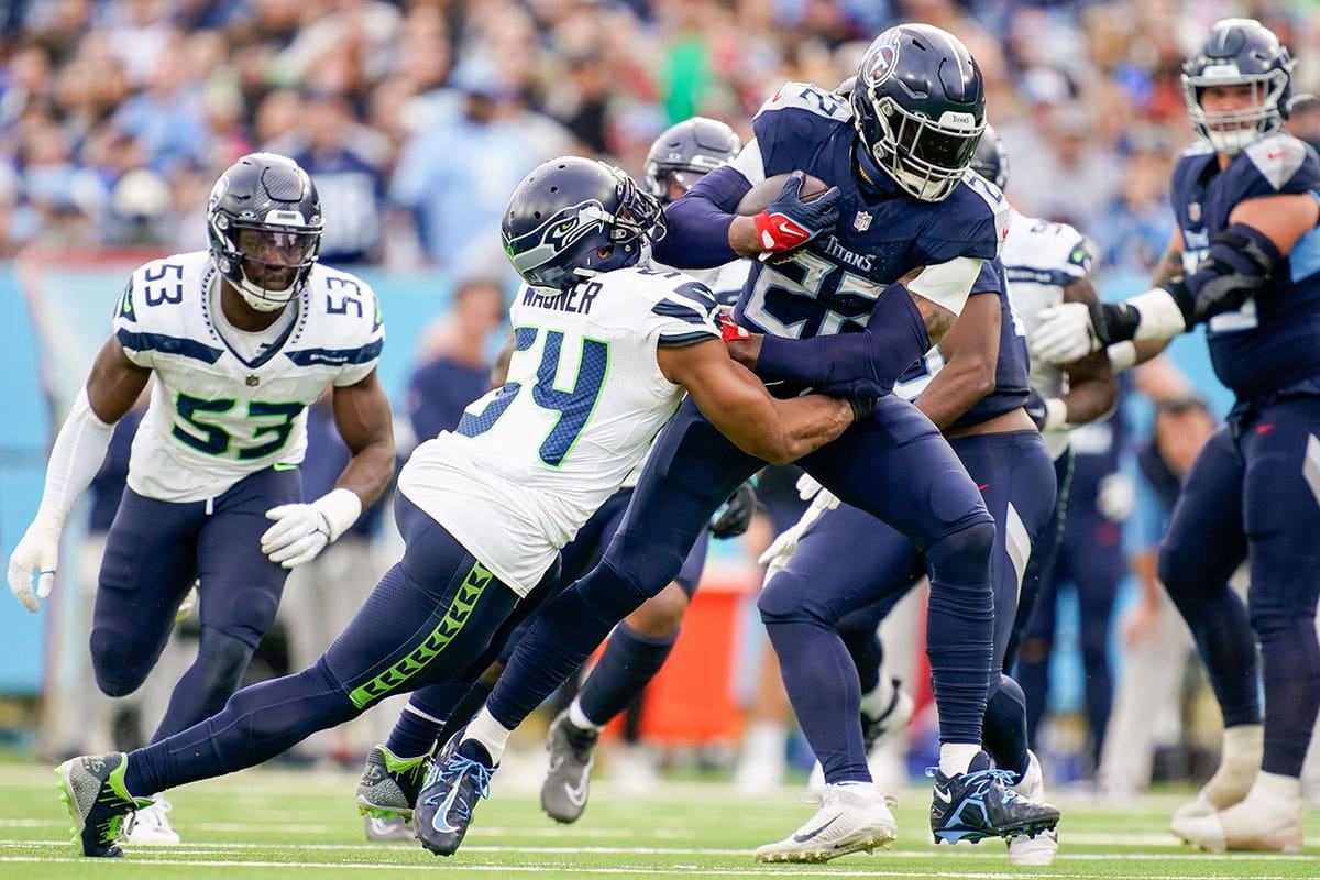 Tennessee Titans running back Derrick Henry (22) is tackled by Seattle Seahawks linebacker Bobby Wagner