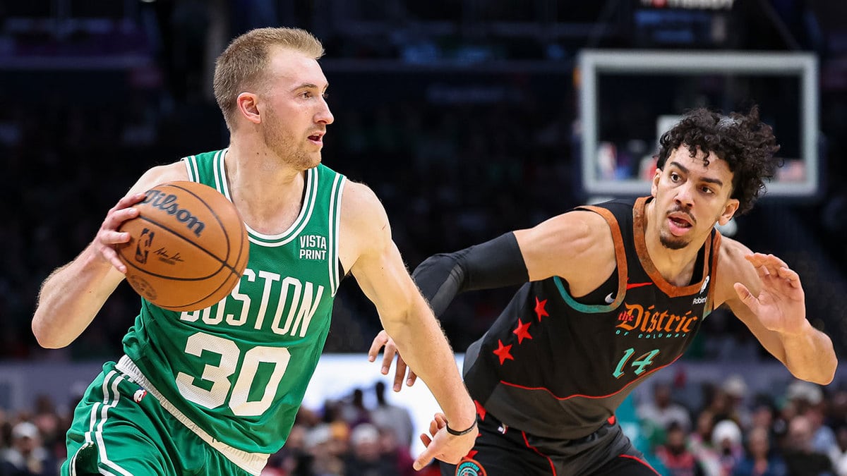 Boston Celtics forward Sam Hauser (30) drives to the basket against Washington Wizards guard Jules Bernard (14) during the first half of the game at Capital One Arena