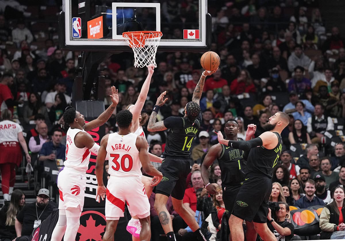 New Orleans Pelicans forward Brandon Ingram (14) drives to the basket over Toronto Raptors guard Ochai Agbaji (30) during the first quarter