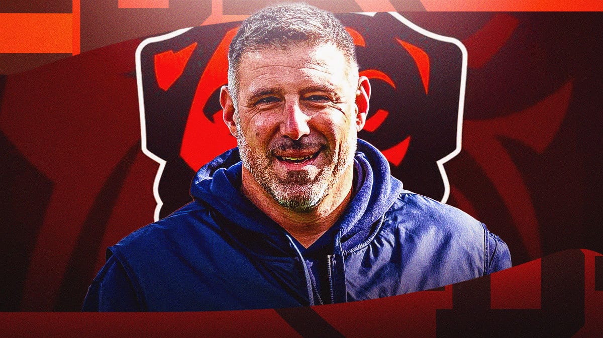 Mike Vrabel smiling, Cleveland Browns logo at the back