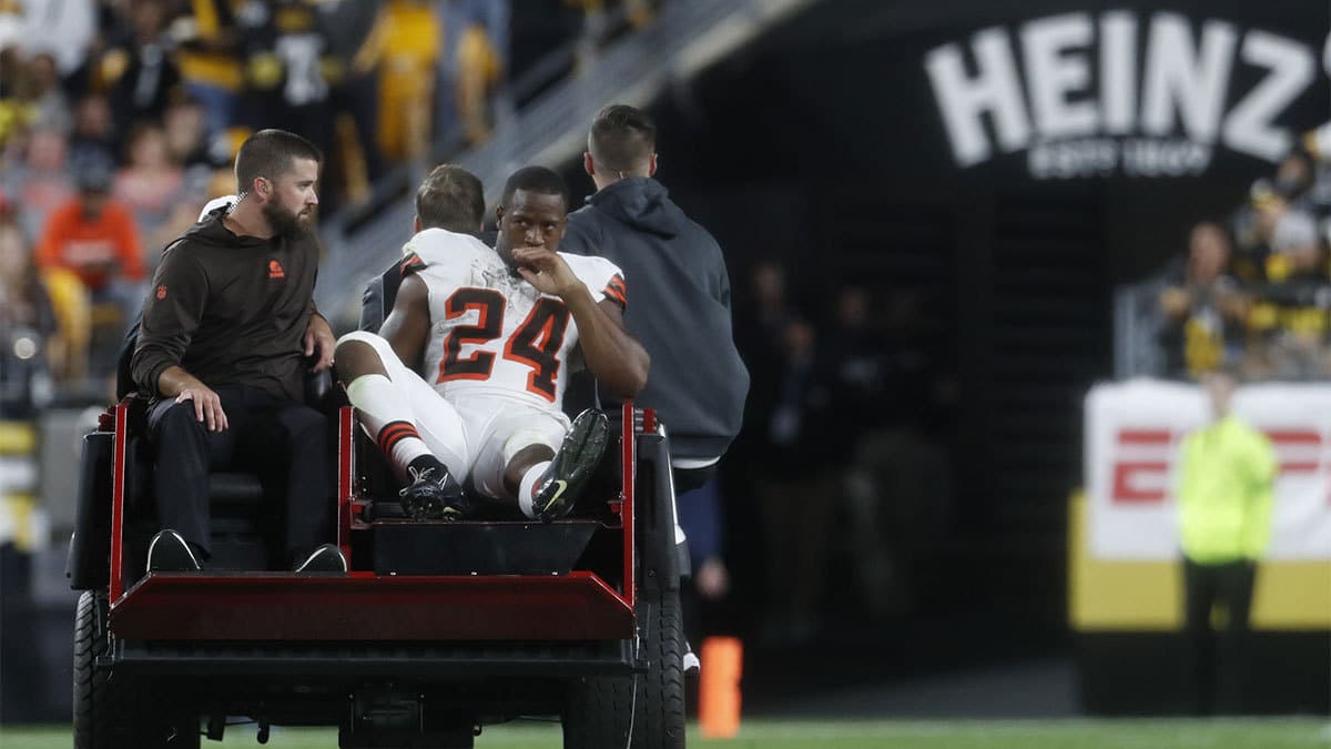 Cleveland Browns running back Nick Chubb (24) is taken from the field on a cart after suffering an apparent injury against the Pittsburgh Steelers during the second quarter at Acrisure Stadium. 