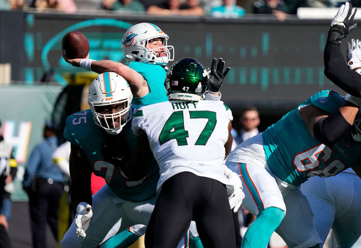Dolphins quarterback Skylar Thompson (19) tries to make a pass in the fourth quarter as Dolphins tackle Greg Little (75) blocks Jets defensive lineman Bryce Huff (47). Sunday, October 9, 2022 Jets Vs Dolphins