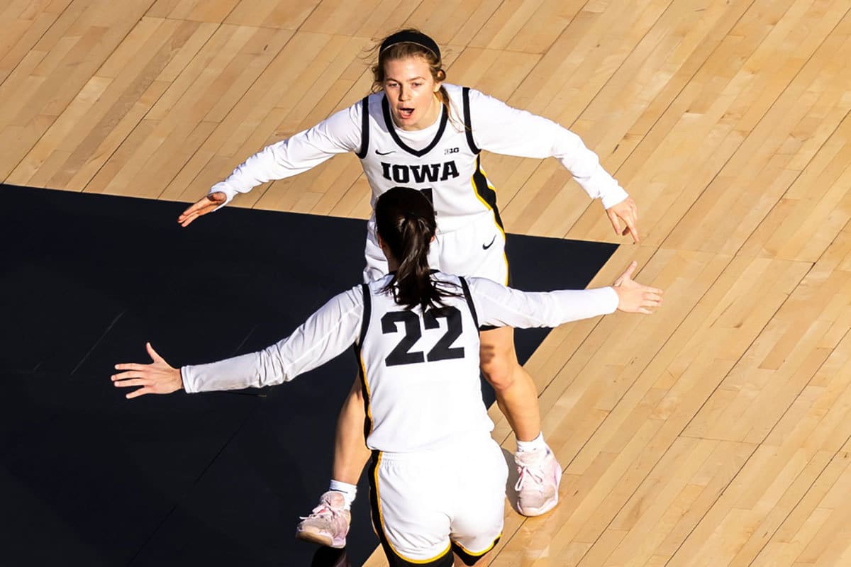 Iowa guard Caitlin Clark (22) celebrates a 3-point basket with teammate Molly Davis during the Crossover at Kinnick women's basketball scrimmage between Iowa and DePaul