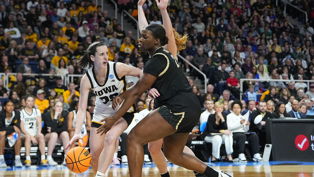 Iowa Hawkeyes guard Caitlin Clark (22) dribbles the ball past Colorado Buffaloes center Aaronette Vonleh (21) in the semifinals of the Albany Regional of the 2024 NCAA Tournament at the MVP Arena.