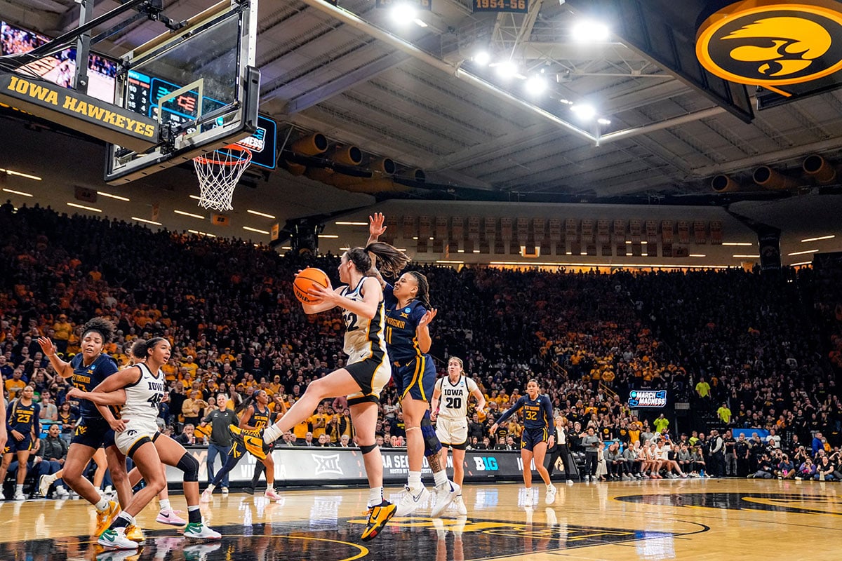 Iowa Hawkeyes guard Caitlin Clark (22) grabs a rebound in a second-round NCAA Tournament game between Iowa and West Virginia,