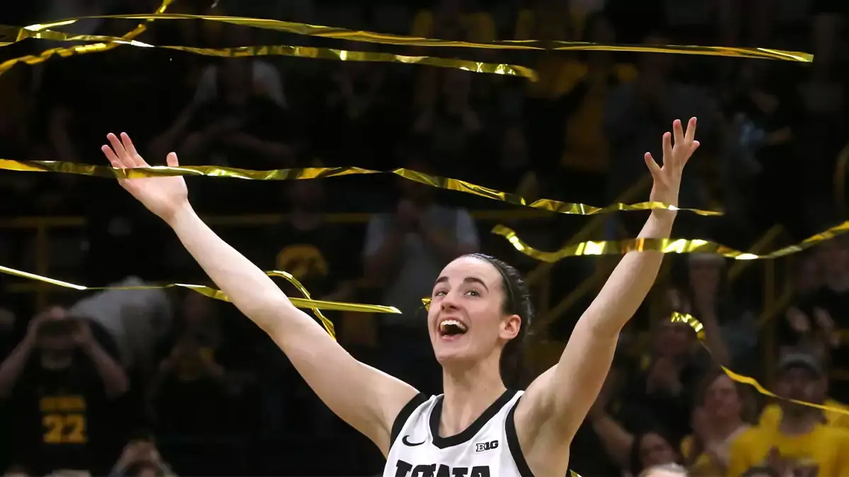 Caitlin Clark reacts as confetti rains down during Iowa's senior recognition after playing Ohio State at Carver-Hawkeye Arena in Iowa City, Iowa. Clark broke Pete Maravich's all-time NCAA scoring record in the Hawkeyes' 93-83 win.