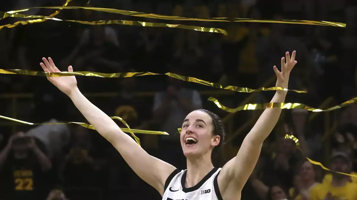 Caitlin Clark reacts as confetti rains down during Iowa's senior recognition after playing Ohio State at Carver-Hawkeye Arena in Iowa City, Iowa. Clark broke Pete Maravich's all-time NCAA scoring record in the Hawkeyes' 93-83 win