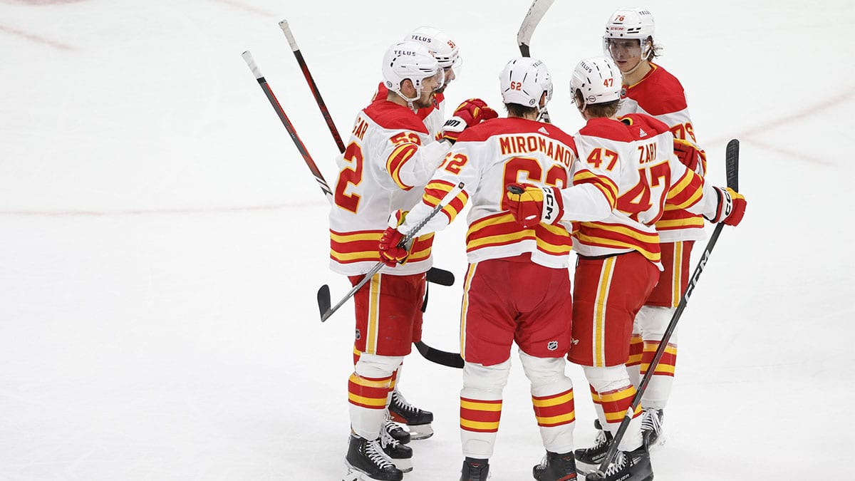 Calgary Flames defenseman MacKenzie Weegar (52) celebrates with teammates after scoring against the Chicago Blackhawks during the third period at United Center.