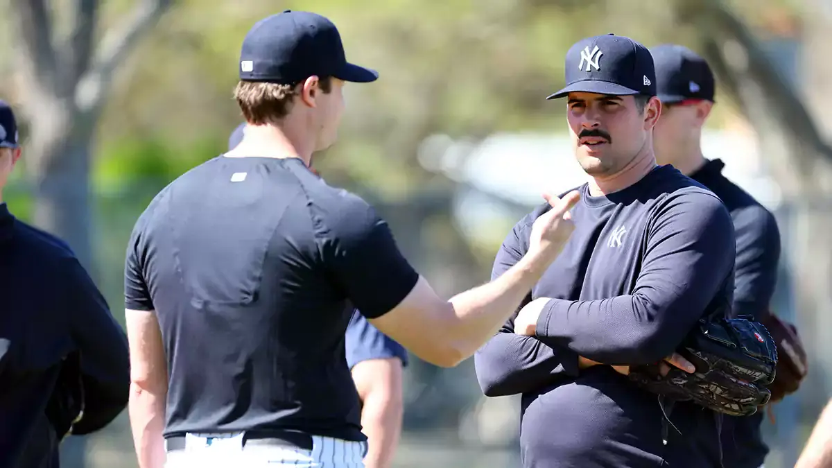  New York Yankees starting pitcher Gerrit Cole (45) and starting pitcher Carlos Rodon (55) talk during spring training practice at George M. Steinbrenner Field.